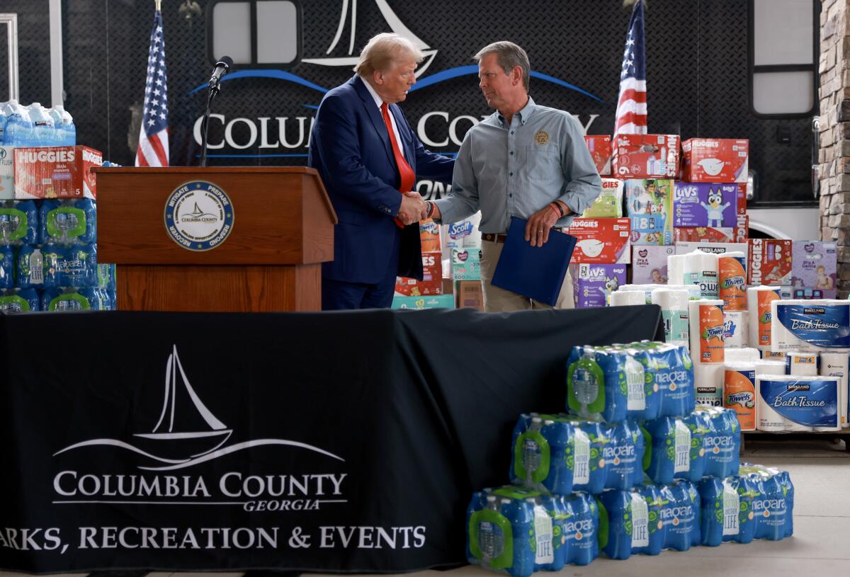 Donald Trump and Georgia Gov. Brian Kemp shake hands in Evans, Ga.