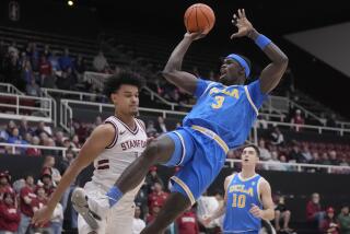 UCLA forward Adem Bona (3) is fouled by Stanford forward Spencer Jones