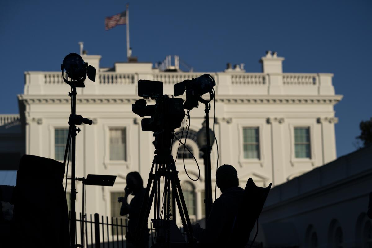 Journalists gather outside the White House in Washington 