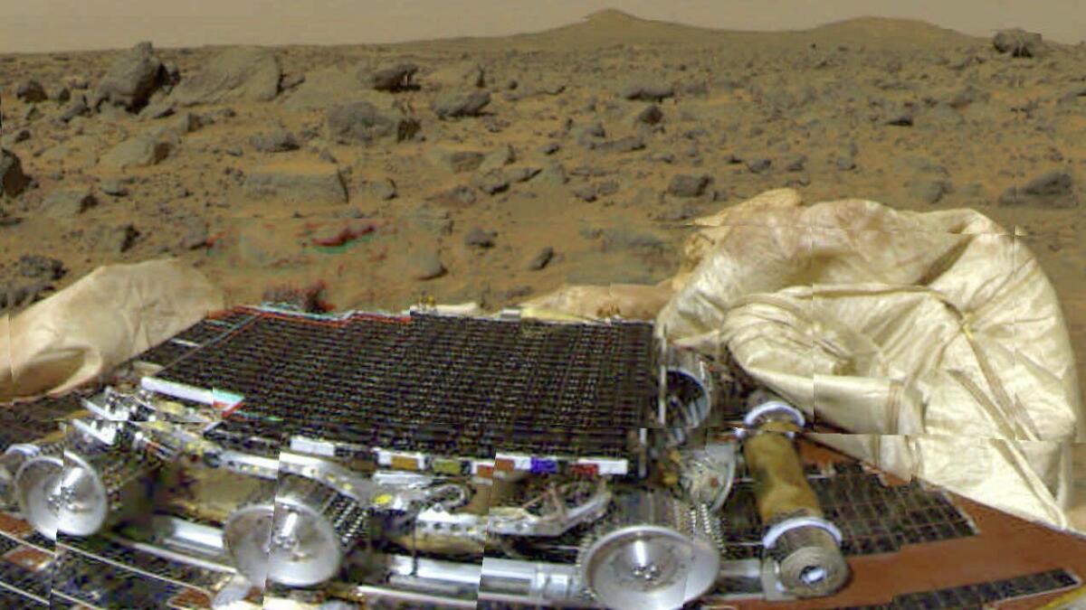 FILE--The Mars Pathfinder rover vehicle and an impact-stopping airbag is shown on the surface of Mars in this image transmitted to Earth from the Mars Pathfinder probe July 4, 1997. A section of the airbags on the right has blocked the path of the rover's exit ramp, delaying the deployment of the rover. (AP Photo/JPL)