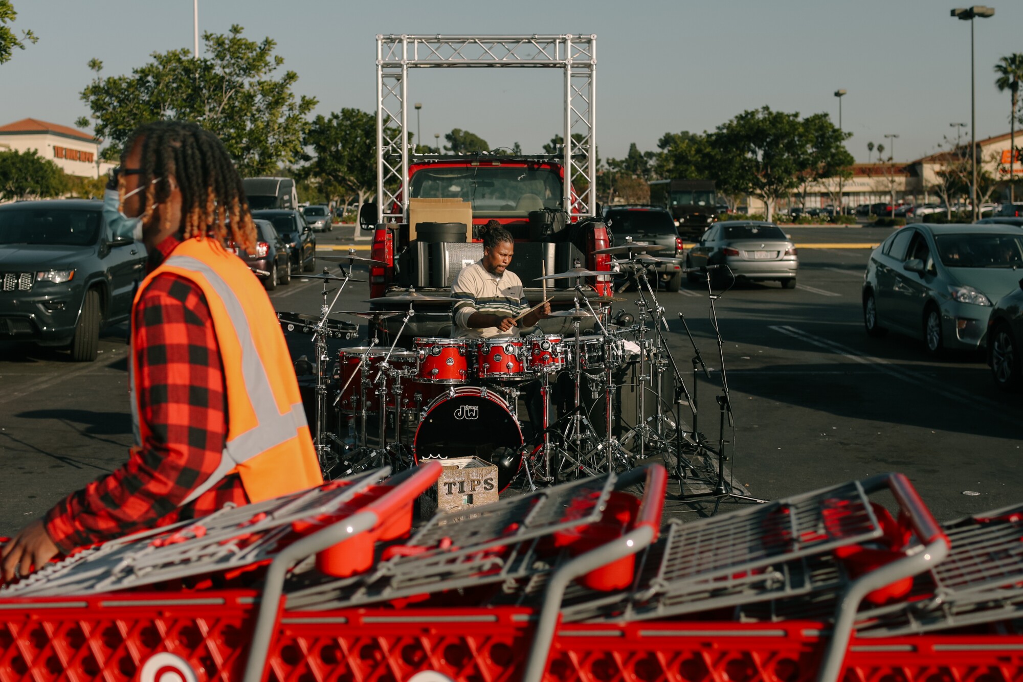 A drummer performs in a Target parking lot.