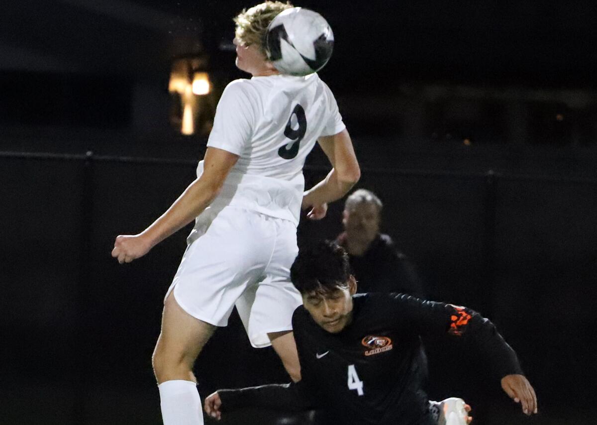 Laguna Beach's Jack Hooper (9) goes up for a header against Los Amigos' Brandon Medina (4) on Tuesday.