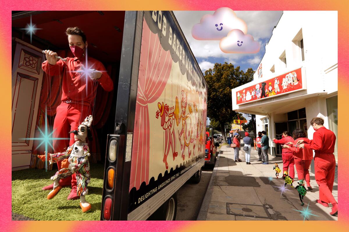 A man plays with a marionette in the back of a truck on the street.