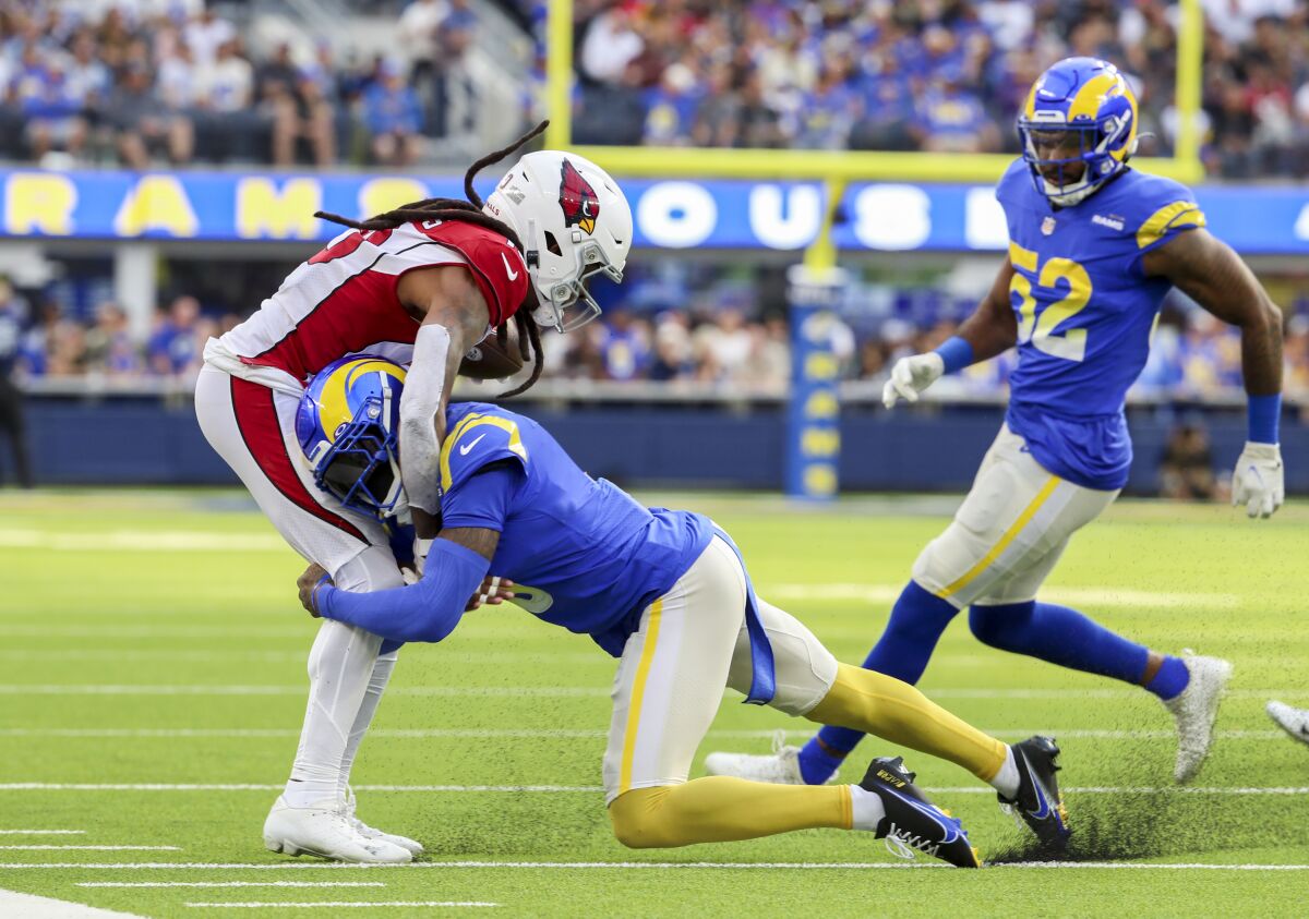 Rams cornerback Jalen Ramsey tackles Cardinals wide receiver DeAndre Hopkins in the first half.