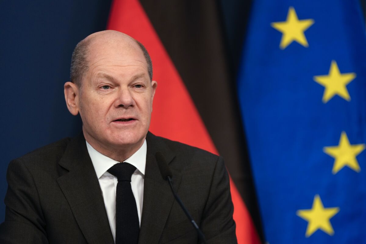 German Chancellor Olaf Scholz sits in front of a camera as he delivers his speech for the Davos Agenda 2022, at the chancellery in Berlin, Germany, Wednesday, Jan. 19, 2022. The Davos Agenda, which takes place from Jan. 17 to Jan. 21, 2022, is an online edition of the annual Davos meeting of the World Economy Forum due to the coronavirus pandemic. (AP Photo/Markus Schreiber, Pool)