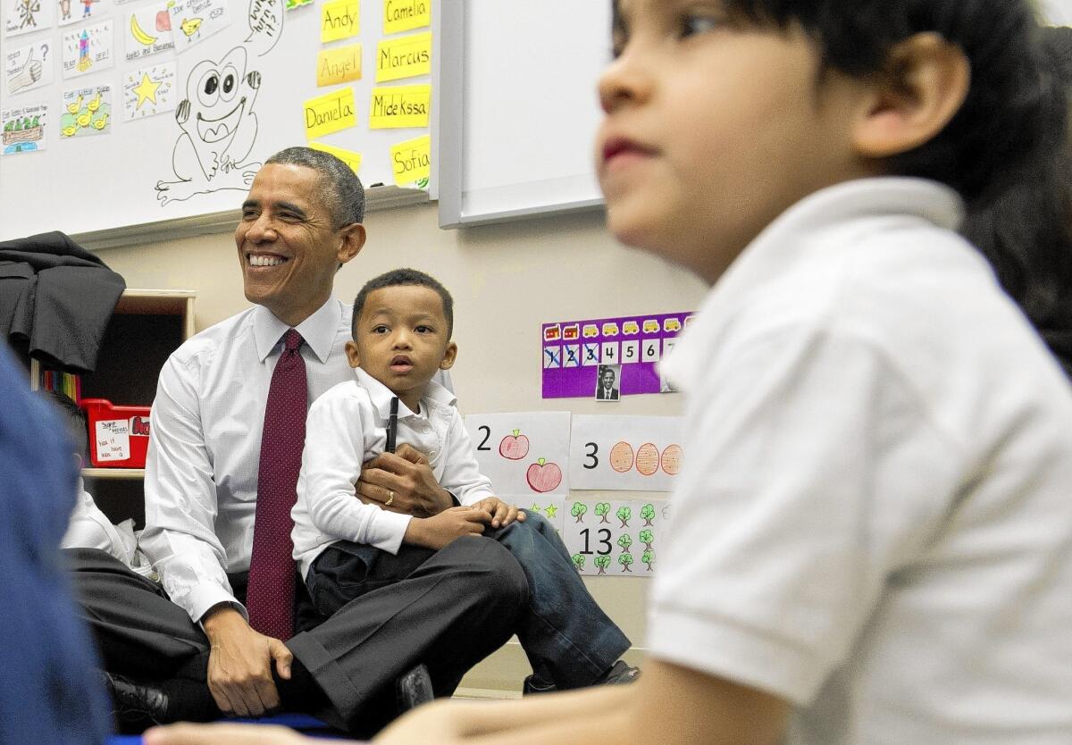 President Obama holds Marcus Wesby during a visit to Powell Elementary School in Washington, where he promoted his spending plan for fiscal year 2015. “Our budget is about choices. It’s about our values,” Obama said.
