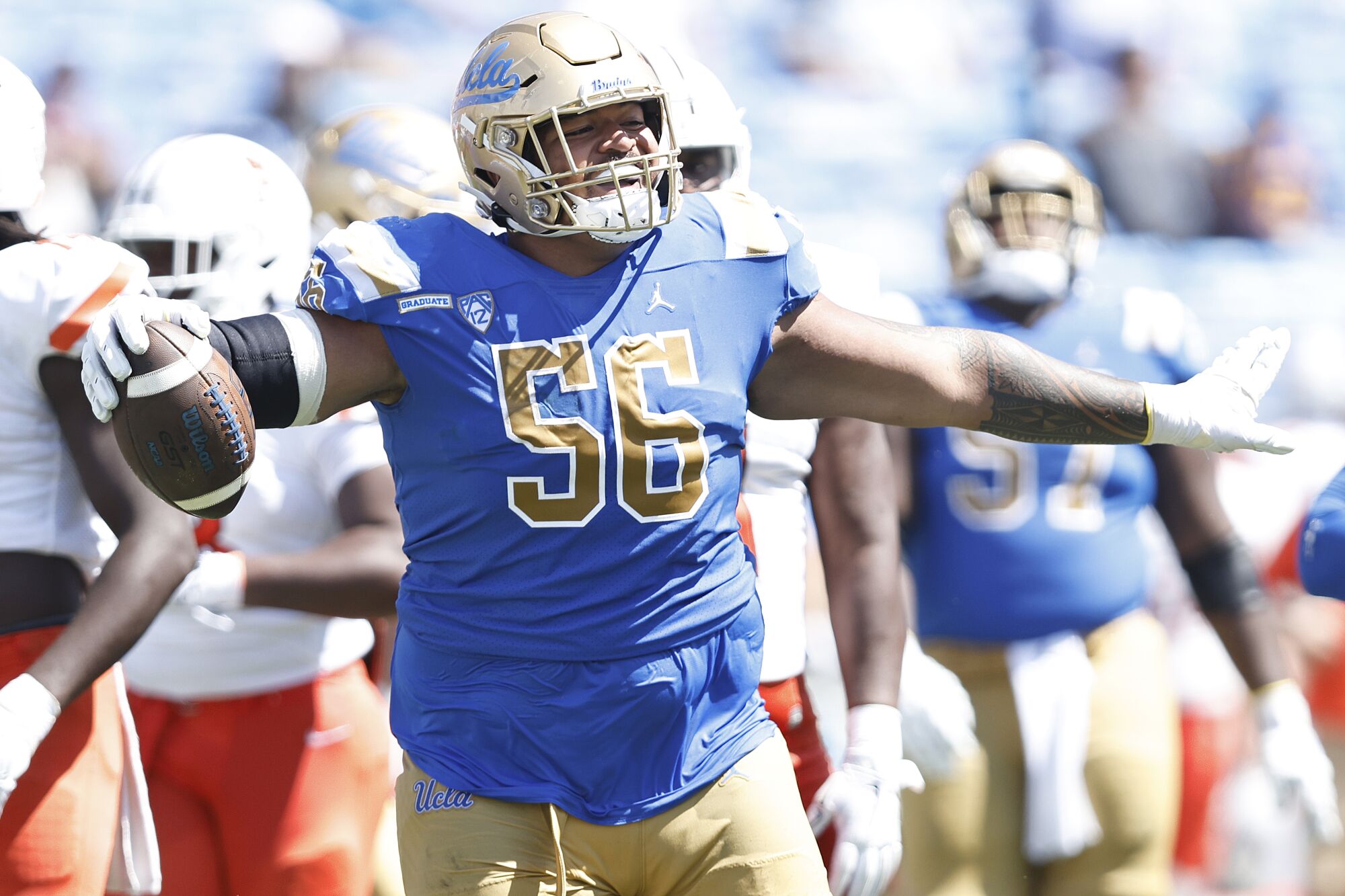 Atonio Mafi of the UCLA Bruins celebrates after recovering a fumble against the Bowling Green Falcons.
