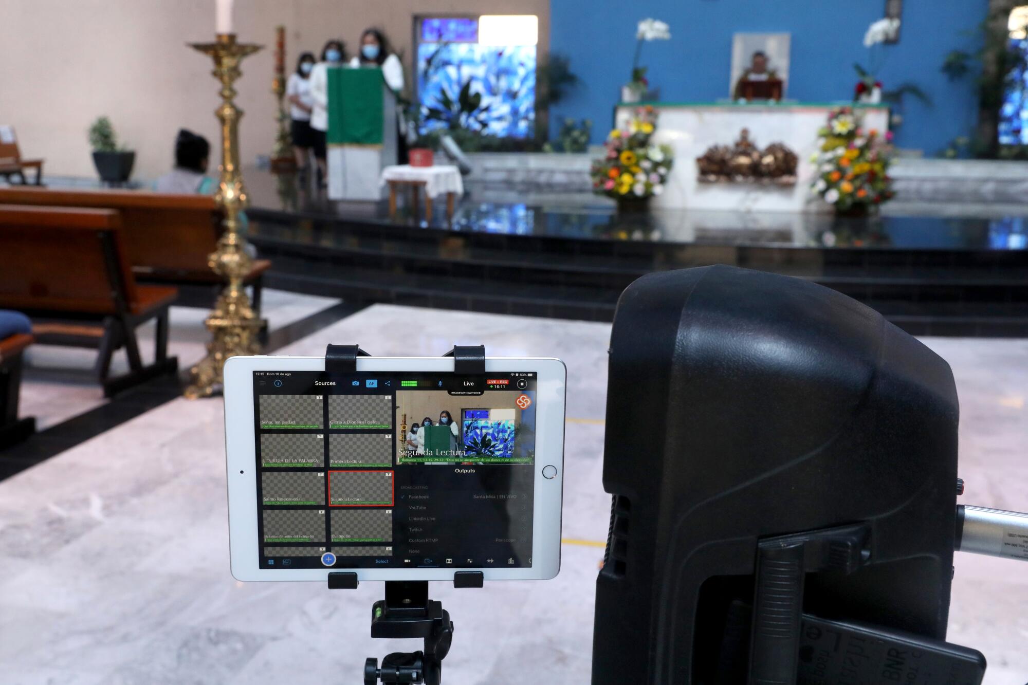 An iPad screen shows livestreamed video of a church service