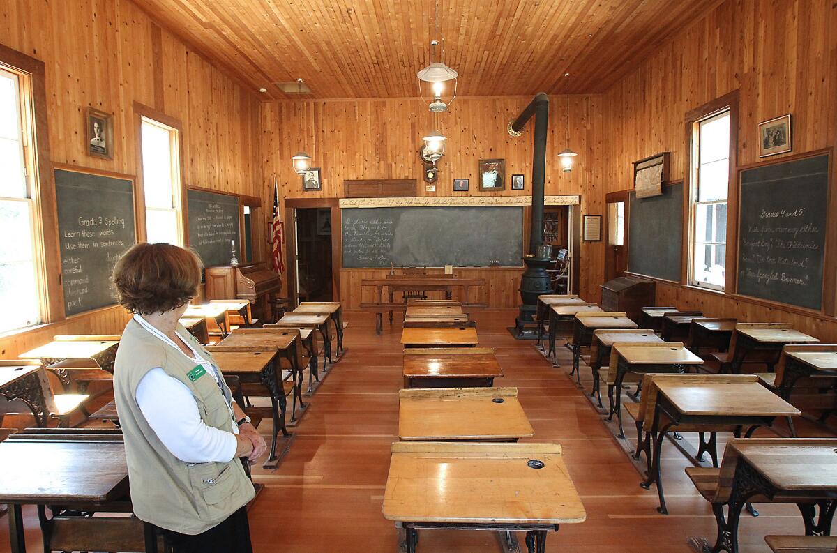 Docent Nancy Jambon gives a tour of the Heritage Hill Historical Park schoolhouse on recent afternoon. The historical park in Lake Forest also features a church and two family homes along with historic artifacts from the ranching days of the Saddleback Valley.