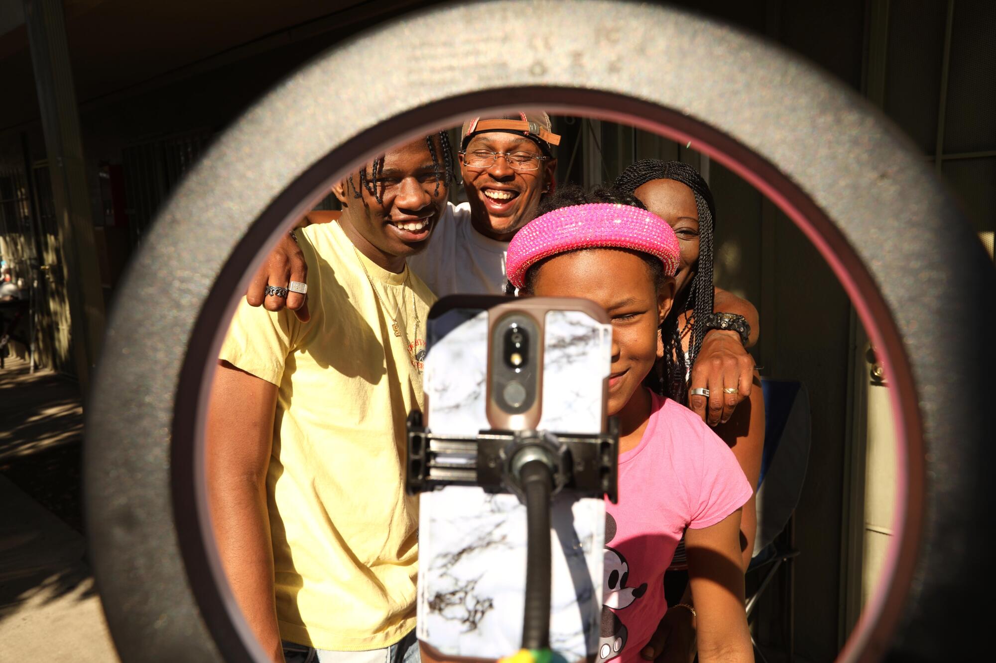 Terrell Weaver, left, poses with his stepfather, sister and mother for a family photo.