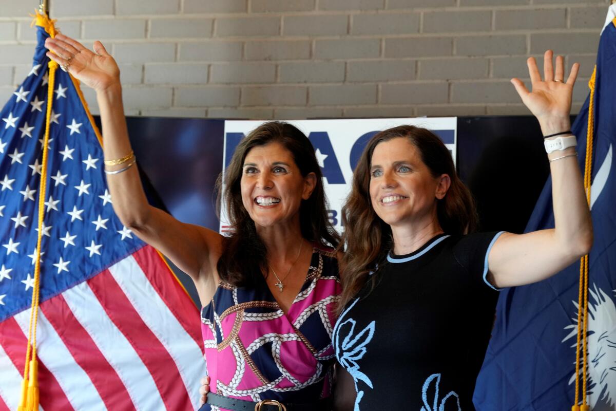 Former South Carolina Gov. Nikki Haley, left, cheers alongside U.S. Rep. Nancy Mace