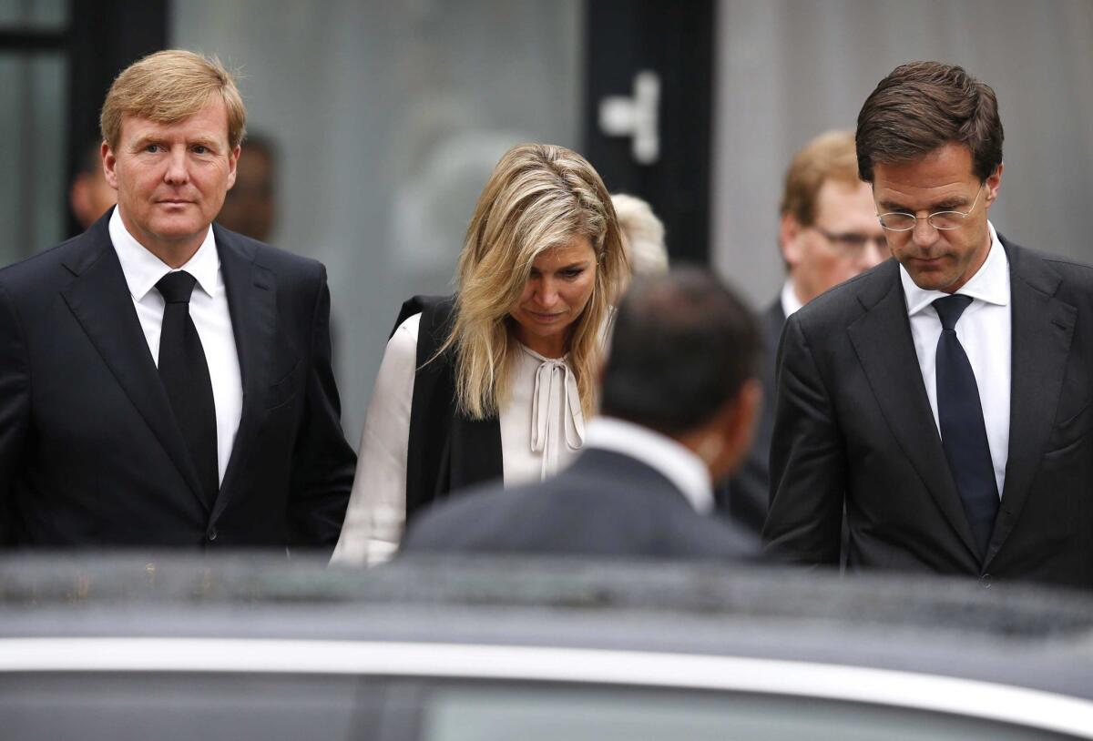 From left, Dutch King Willem-Alexander, Queen Maxima and Prime Minister Mark Rutte leave after a meeting with relatives of the victims of Malaysia Airlines Flight 17 near Utrecht on July 21.