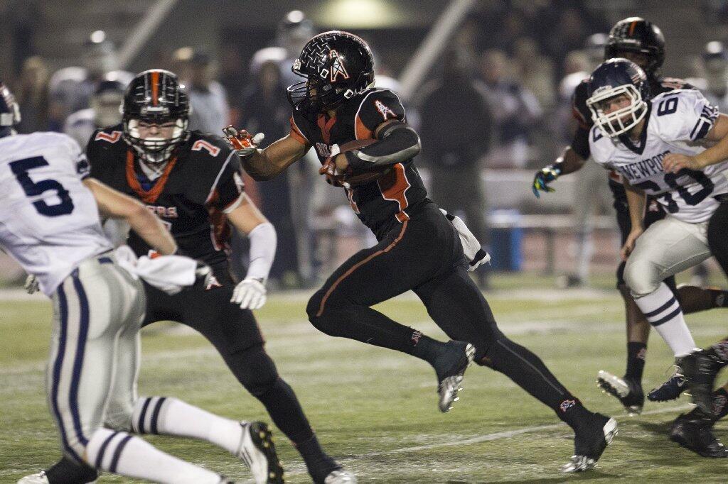 Huntington Beach's Kai Ross nearly scores a touchdown on a kickoff return against Newport Harbor during a game on Friday.