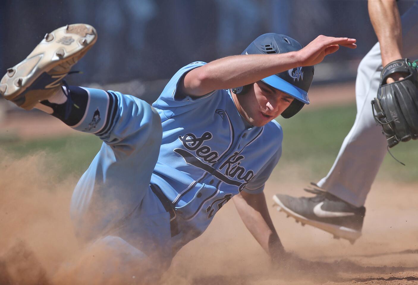 Corona del Mar's Anthony DiFerdinando slides into home under the tag during nonleague baseball game against Costa Mesa on Saturday.