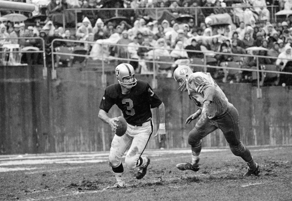 Oakland Raiders quarterback Daryle Lamonica scrambles to avoid San Francisco's Charley Kreuger.