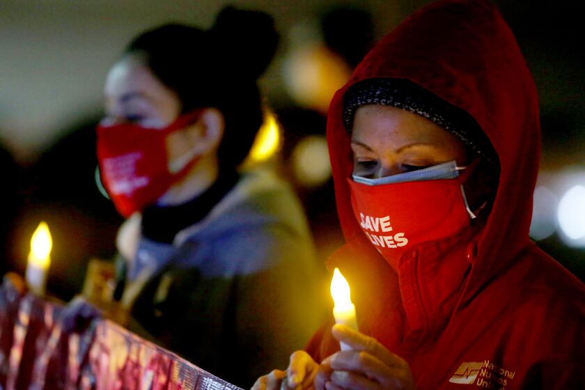 Registered nurses at UCLA Medical Center hold a nighttime vigil 