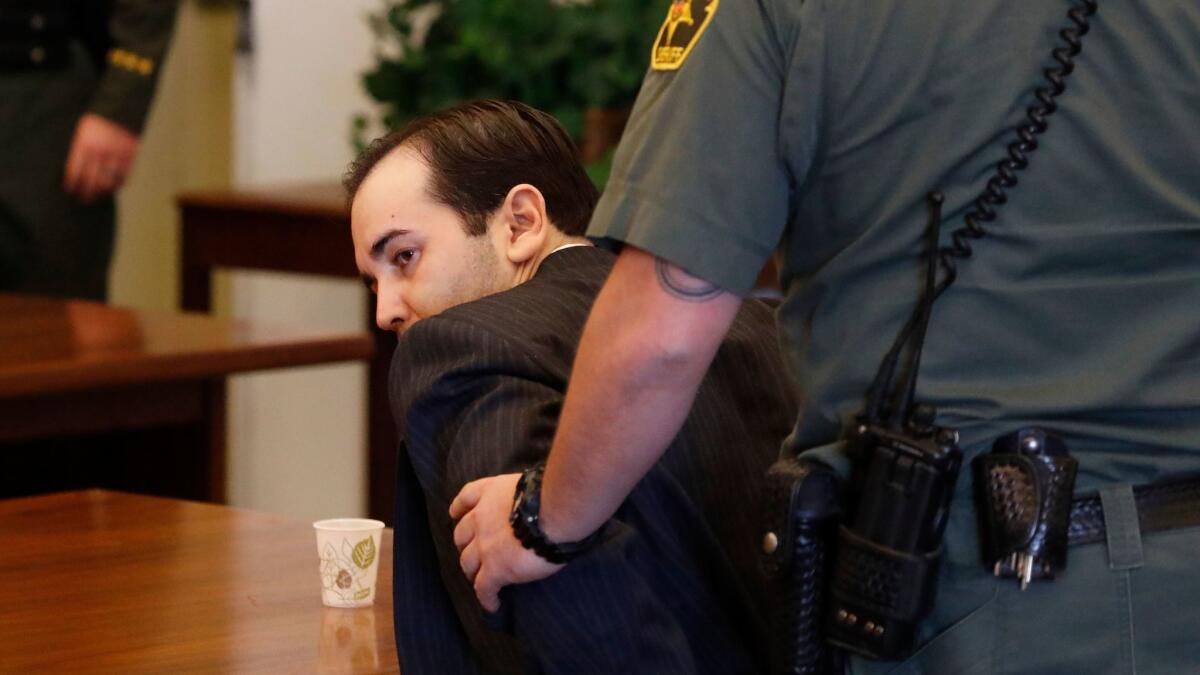 An Orange County sheriff's bailiff handcuffs Kyle Handley after he was found guilty of kidnap, torture and mayhem.