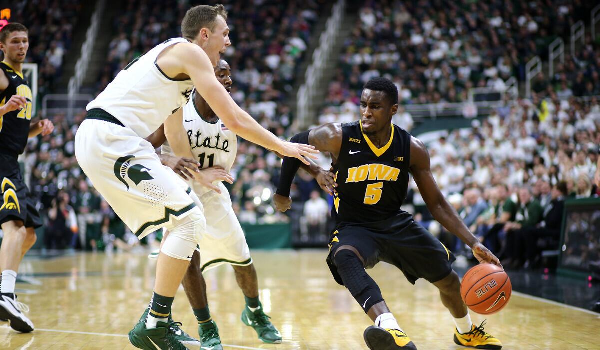 Iowa's Anthony Clemmons, right, drives to the basket against Michigan State's Colby Wollenman in the first half on Thursday.