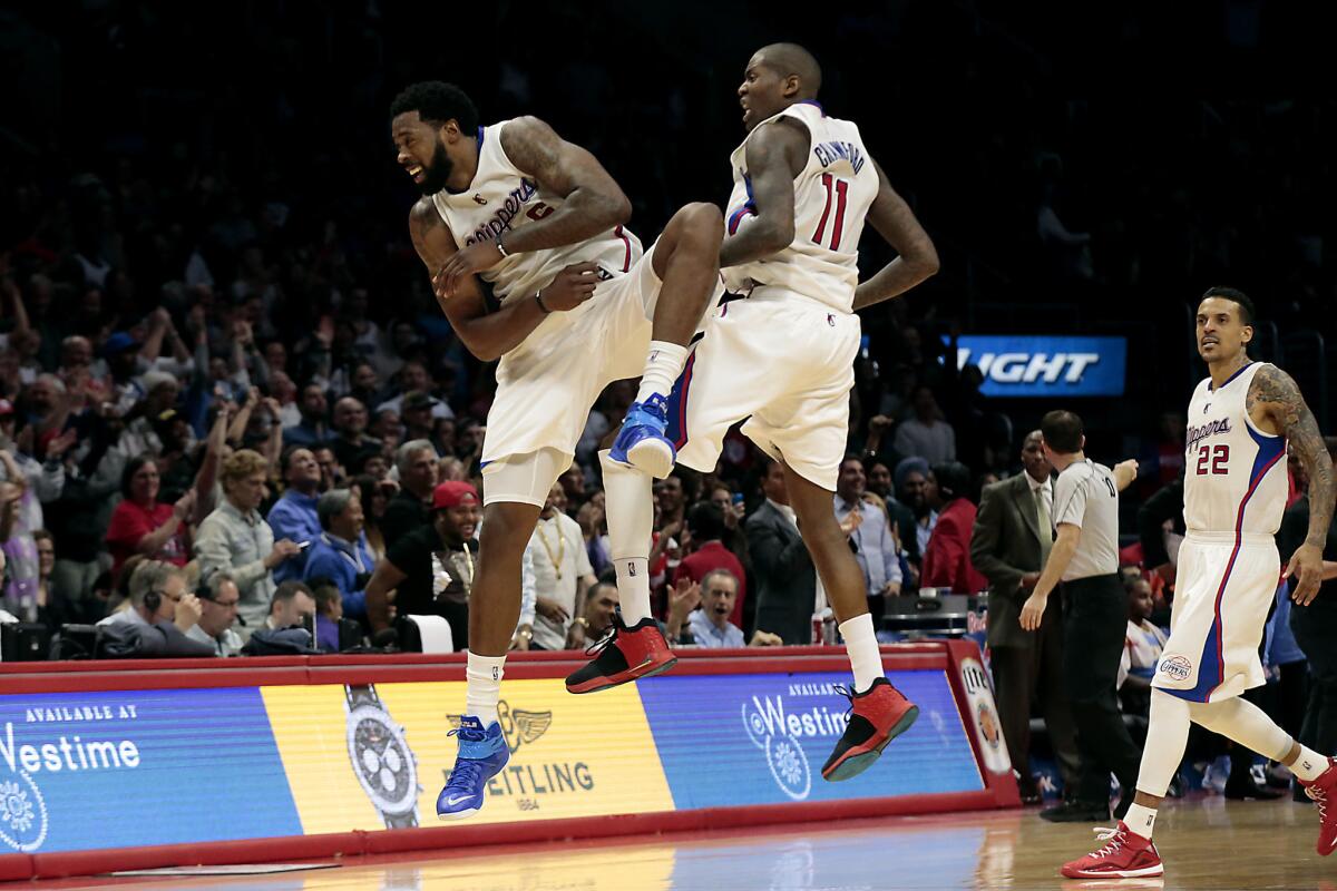 Clippers teammates DeAndre Jordan (6) and Jamal Crawford (11) celebrate after a late basket in the Clippers' 102-98 victory.