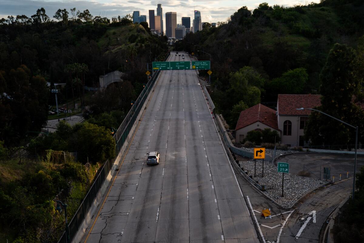 What is normally rush hour on the 110 Freeway finds just a lone vehicle on the road in Elysian Park on Friday.