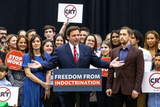 Florida Gov. Ron DeSantis addresses the crowd before publicly signing HB7, "individual freedom," also dubbed the "stop woke" bill during a news conference at Mater Academy Charter Middle/High School in Hialeah Gardens, Fla., on Friday, April 22, 2022. DeSantis also signed two other bills into laws including one regarding the "big tech" bill signed last year but set aside due to a court ruling, and the special districts bill, which relates to the Reedy Creek Improvement District. (Daniel A. Varela/Miami Herald via AP)