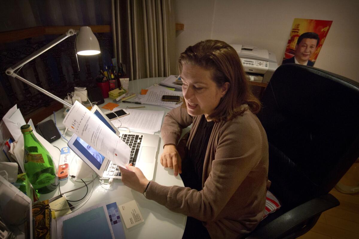 French journalist Ursula Gauthier holds a statement from the Chinese Ministry of Foreign Affairs criticizing her.