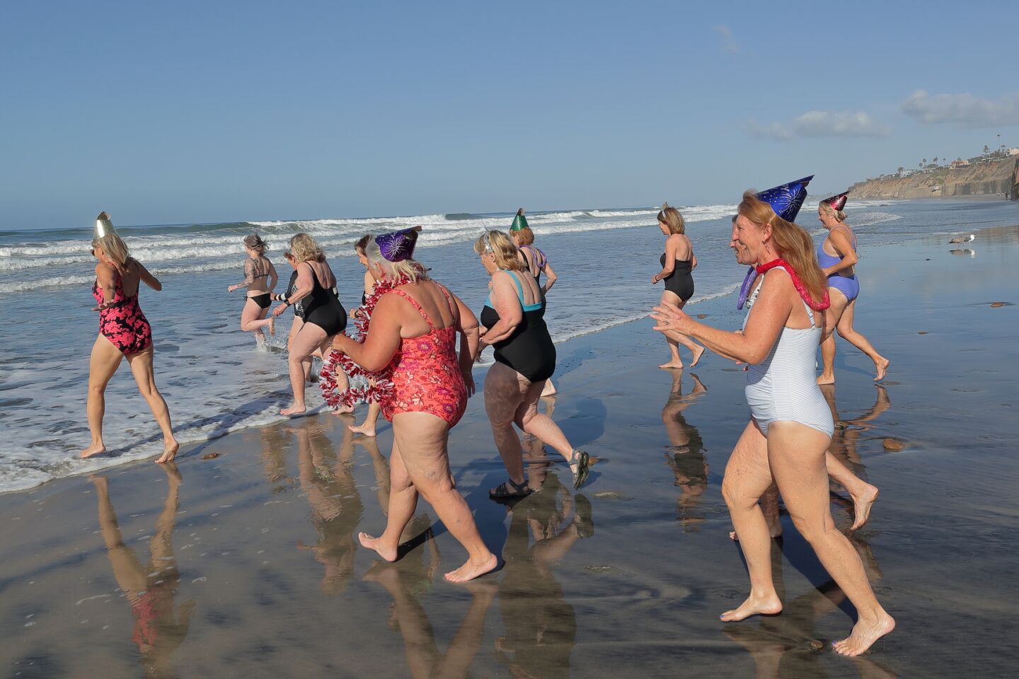 Members of the San Dieguito Boogie Babes plunged into the ocean on New Years Day 2022 at Fletcher Cove in Solana Beach