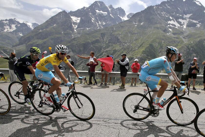 Vincenzo Nibali, wearing the overall leader's yellow jersey, follows teammates as they climb Lautaret pass in the Alps during the 14th stage of the Tour de France on Saturday.