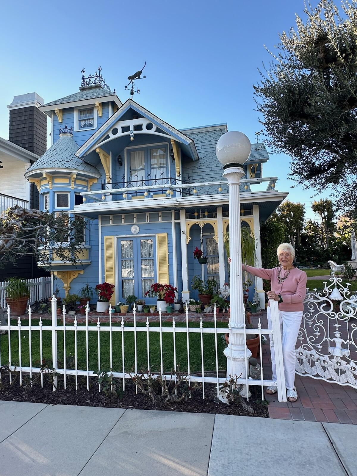 In a recent photo, homeowner Jane Croul, 93, poses in front of her Victorian home.