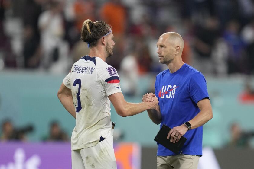 head coach Gregg Berhalter of the United States, right, embraces Walker Zimmerman of the United States at the end of the World Cup round of 16 soccer match between the Netherlands and the United States, at the Khalifa International Stadium in Doha, Qatar, Saturday, Dec. 3, 2022. (AP Photo/Natacha Pisarenko)