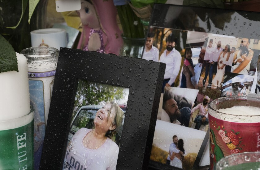 A photo of Joana Cruz, foreground, is seen at a makeshift memorial, Tuesday, May 11, 2021, in Colorado Springs, Colo. Cruz was the matriarch of the family in which six were shot to death early Mother's Day morning. Authorities say the man who fatally shot six people at a birthday party before killing himself was upset after not being invited to the weekend gathering thrown by his girlfriend’s family. (Jerilee Bennett/The Gazette via AP)