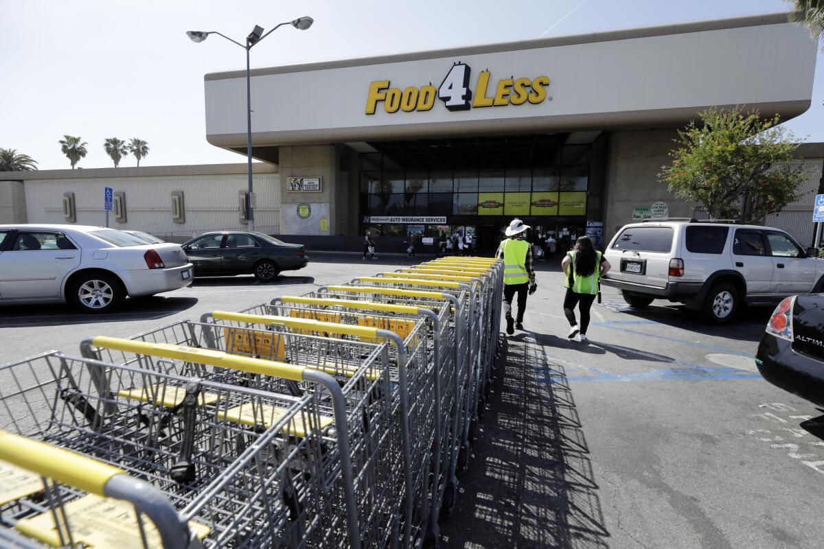 Shopping carts outside a Food 4 Less, one of the chains operated by Kroger.