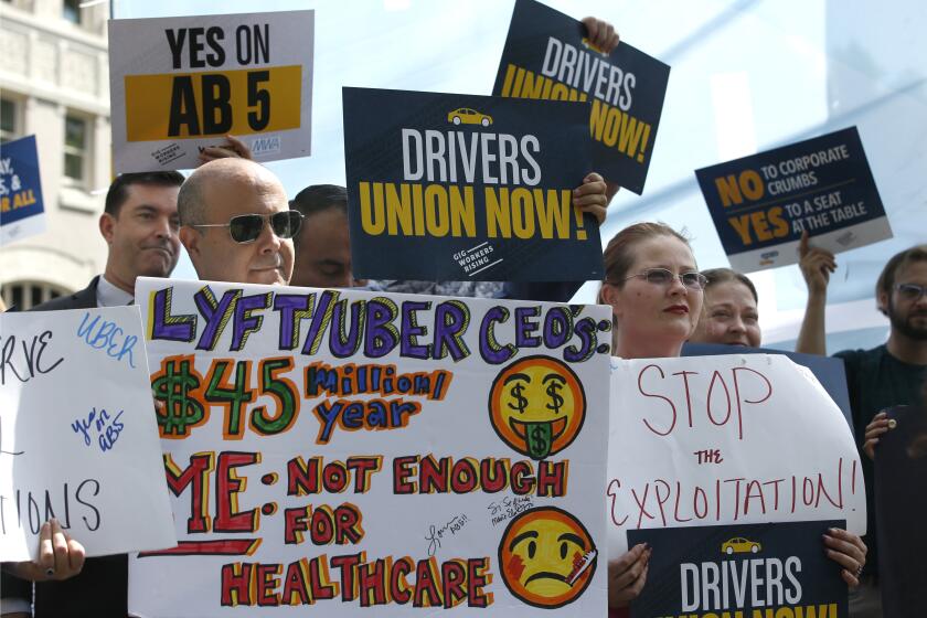 Dozens of supporters of a measure to limit when companies can label workers as independent contractors rally at the Capitol in Sacramento, Calif., Wednesday, Aug. 28, 2019. If approved by the legislature and signed by Gov. Gavin Newsom, AB5, by Assemblywoman Lorena Gonzalez, D-San Diego, would require companies like Uber and Lyft to treat their drivers like employees. (AP Photo/Rich Pedroncelli)