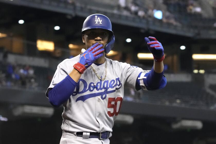 Los Angeles Dodgers Mookie Betts reacts after hitting a solo home run against the Arizona Diamondbacks in the ninth inning during a baseball game, Sunday, Aug 1, 2021, in Phoenix. (AP Photo/Rick Scuteri)