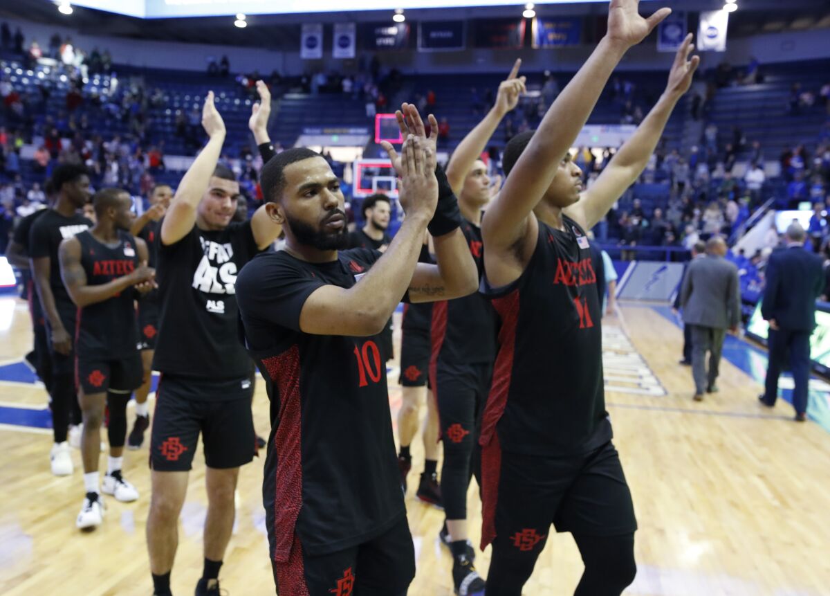 San Diego State guard KJ Feagin, front, and forward Matt Mitchell wave to fans after the second half of an NCAA college basketball game against Air Force.