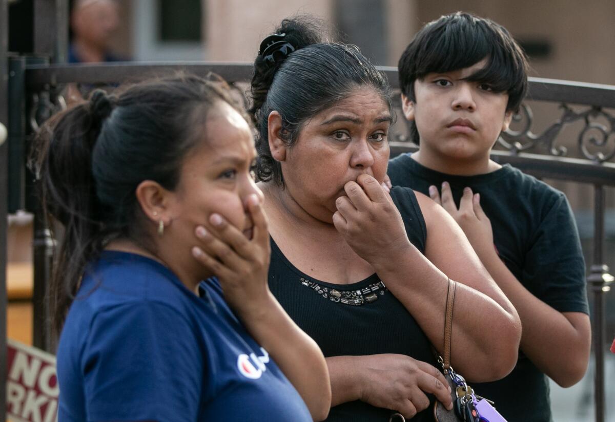 Emotional neighbors with concerned expressions stand outside