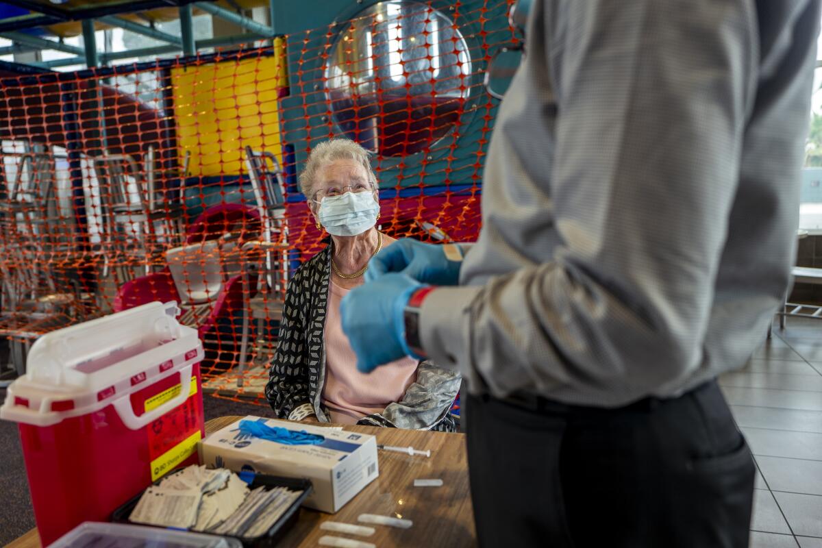 A woman gets a booster shot at a McDonald's.