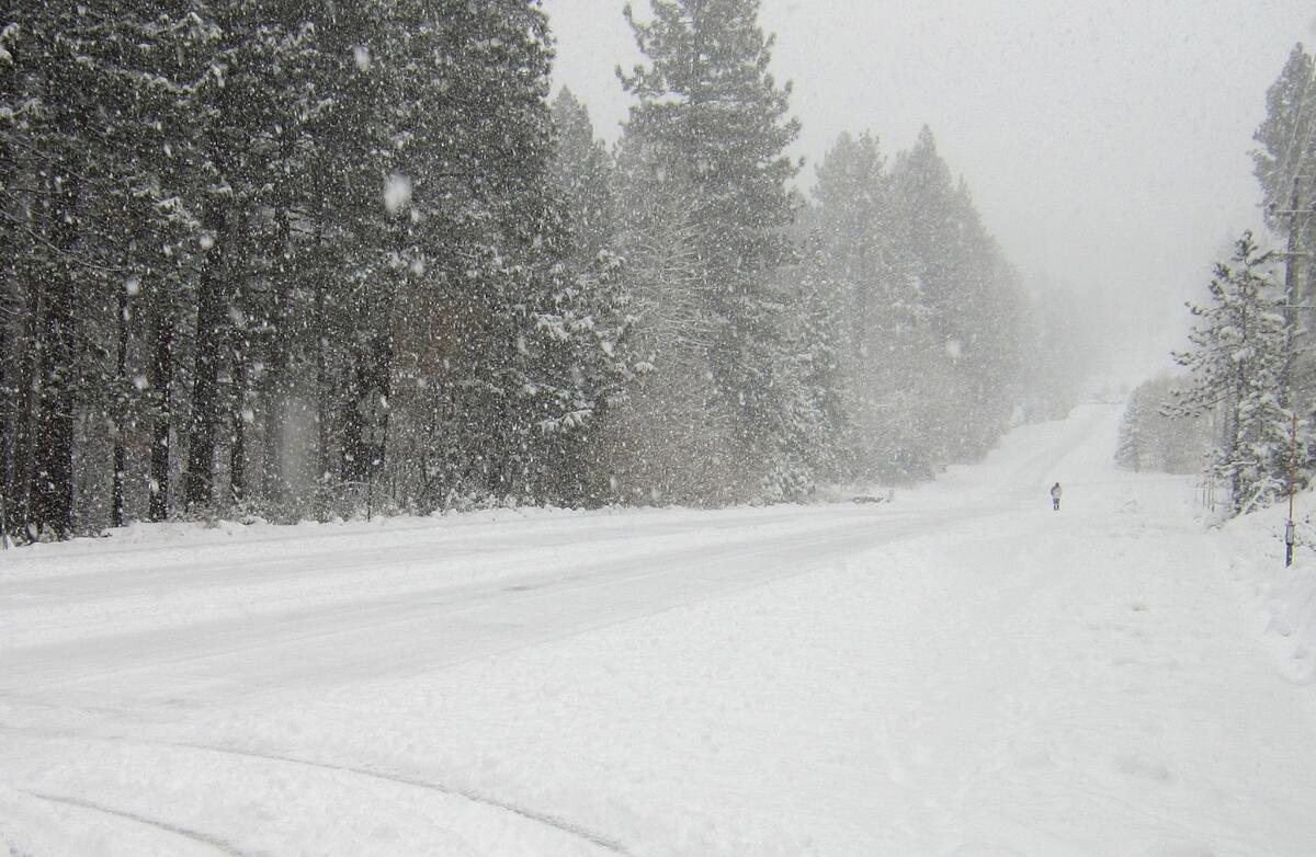 A pedestrian walks in the snow along Ski Run Boulevard in South Lake Tahoe, Calif., on Tuesday, Nov. 10, 2015.