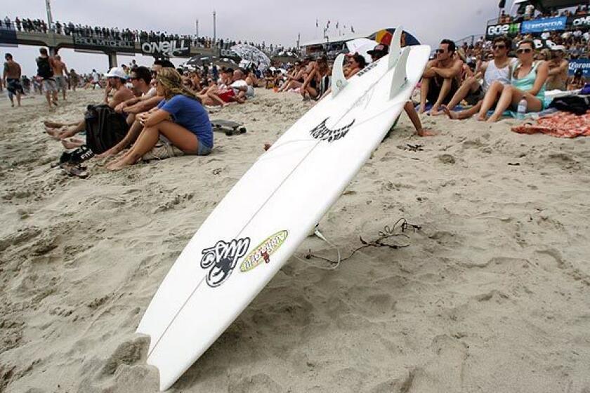 People wait on the beach for the women's final start Saturday at the U.S. Open of Surfing in Huntington Beach.