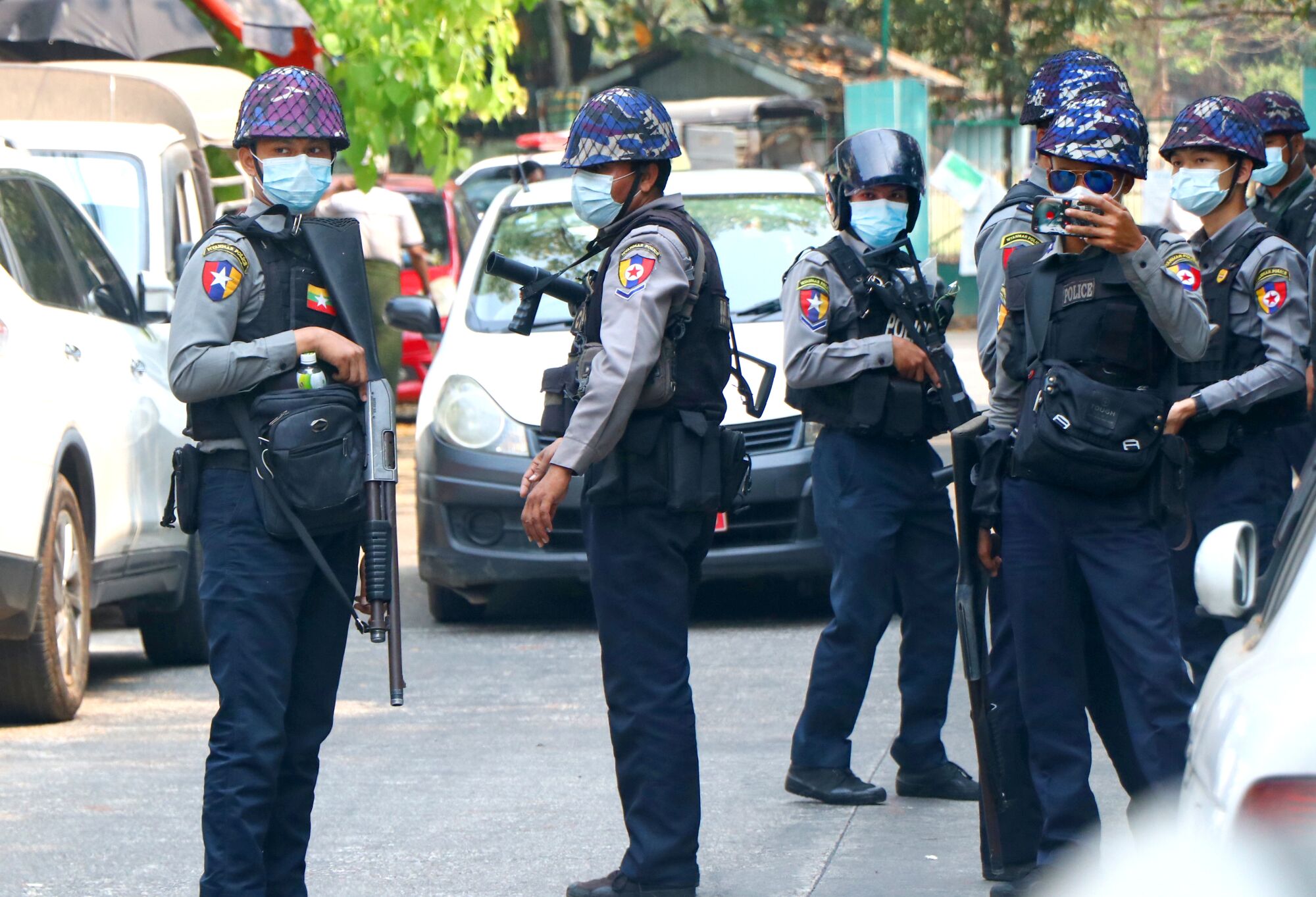 Police gather outside a court in Yangon.