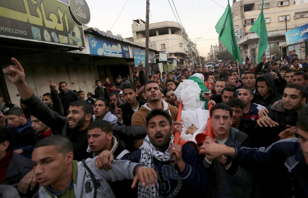 Mourners carry the body of Bilal Samer Oweidah during his funeral in Beit Lahiya, in the northern Gaza Strip. He was shot by Israeli troops during a violent protest along the border with Israel.