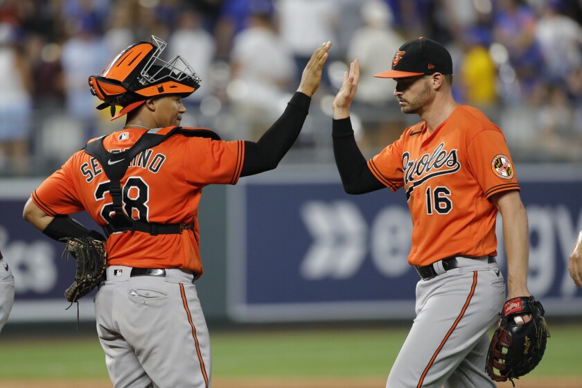 Baltimore Orioles catcher Pedro Severino (28) and right fielder Trey Mancini (16) celebrate at the end of a baseball game against Kansas City Royals at Kauffman Stadium in Kansas City, Mo., Saturday, July 17, 2021. (AP Photo/Colin E. Braley)