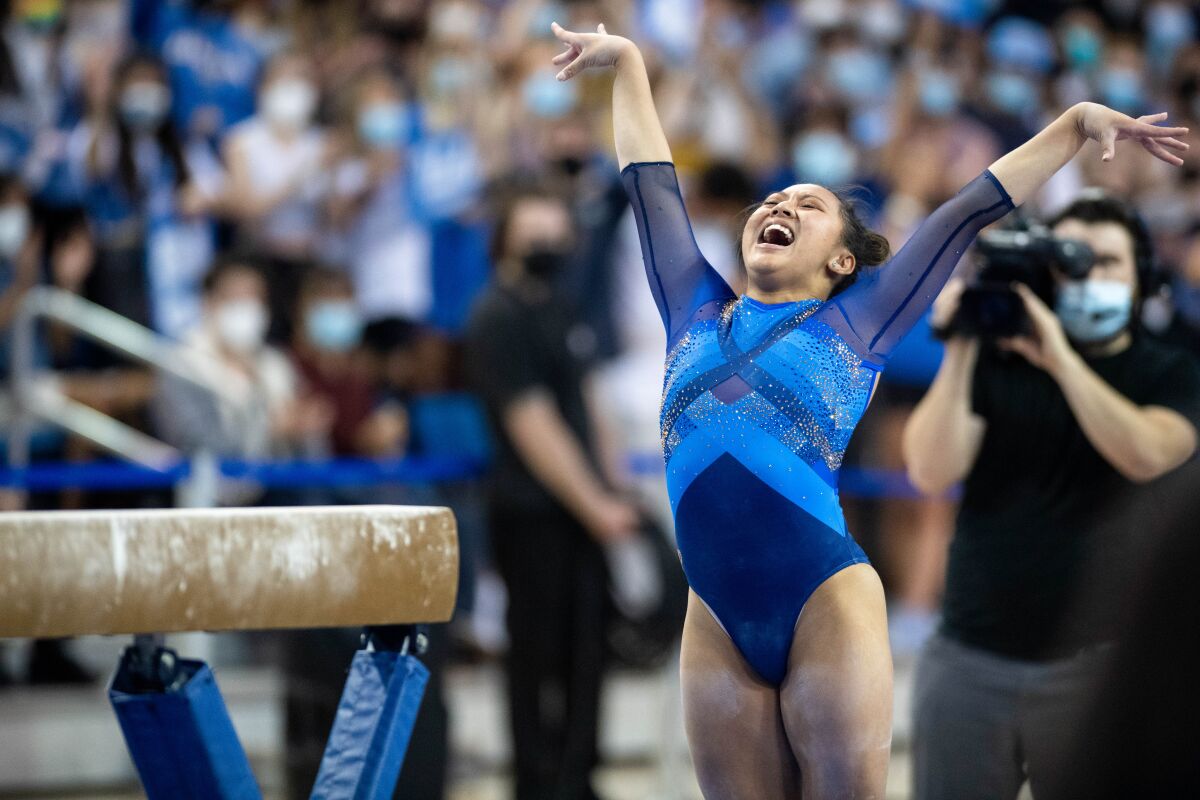 UCLA's Emma Malabuyo celebrates her performance on the balance Beam during an NCAA gymnastics meet.