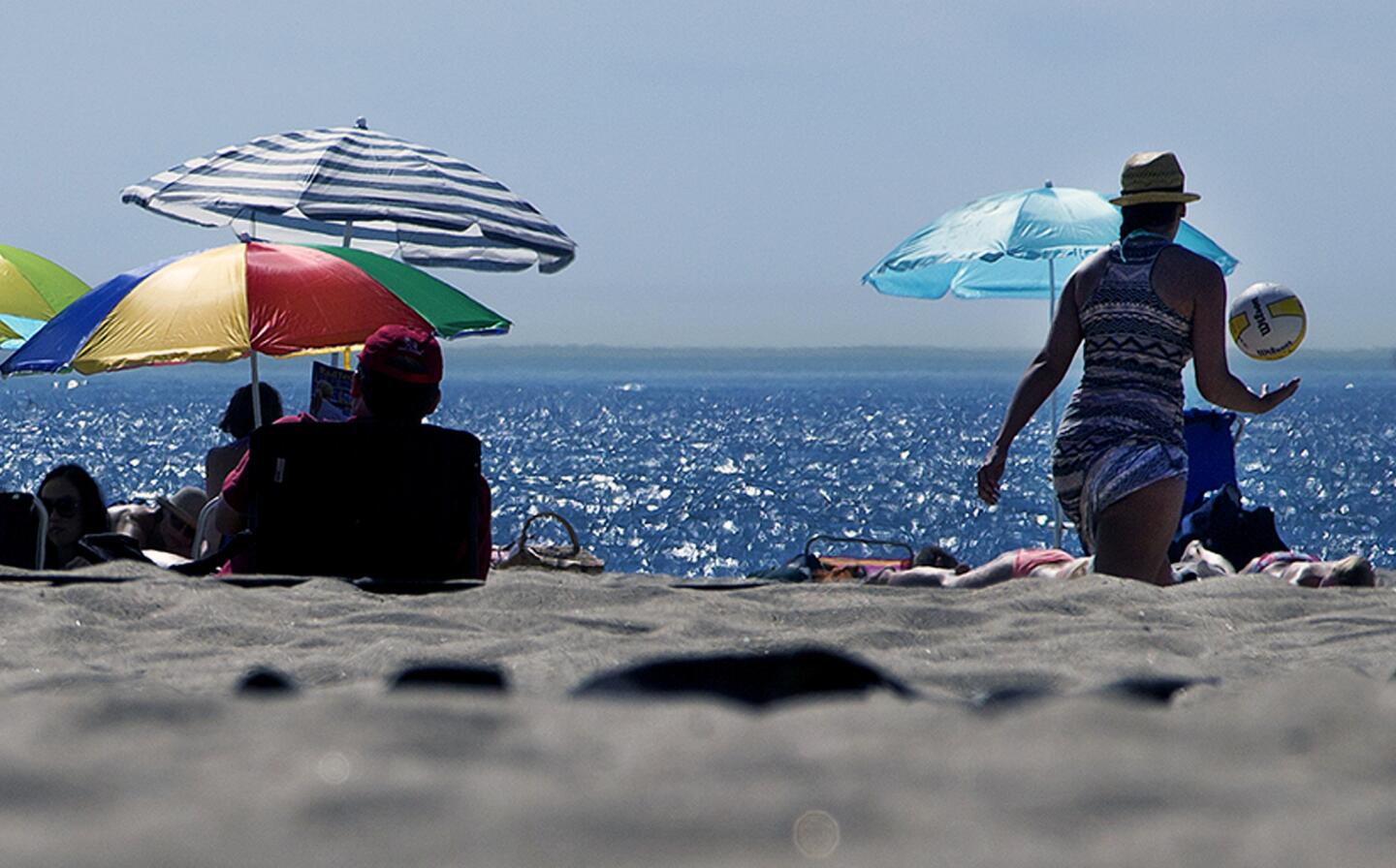 Unseasonably hot weather bought crowds to the beach as temperatures reached 90 degrees Saturday in Laguna Beach.
