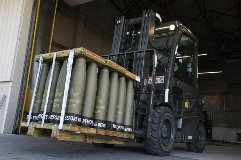 FILE - Airmen with the 436th Aerial Port Squadron use a forklift to move 155 mm shells ultimately bound for Ukraine, April 29, 2022, at Dover Air Force Base, Del. Officials say the U.S. will send Ukraine about $500 million in ammunition and equipment and will spend more than $2 billion to buy an array of munitions, radar and other weapons in the future. (AP Photo/Alex Brandon)