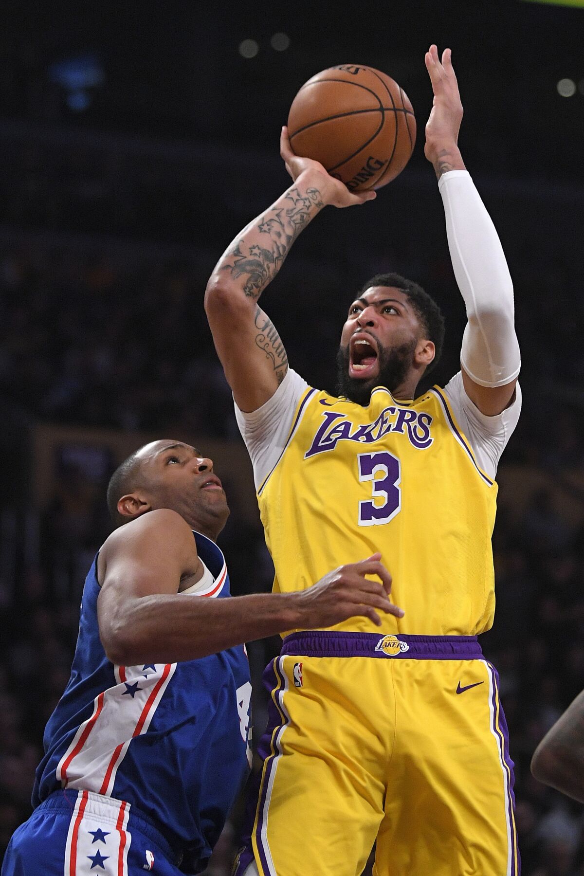 Anthony Davis puts a shot up over the 76ers' Al Horford during the first half of a game March 3 at Staples Center.