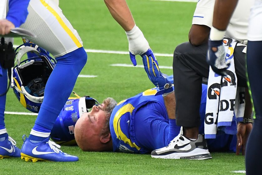 LOS ANGELES, CALIFORNIA NOVEMBER 15, 2020-Rams offensive lineman Andrew Whitworth is given support after an injury against the Seahawks in the 2nd quarter at SoFi Stadium in Inglewood Sunday. (Wally Skalij/Los Angeles Times)