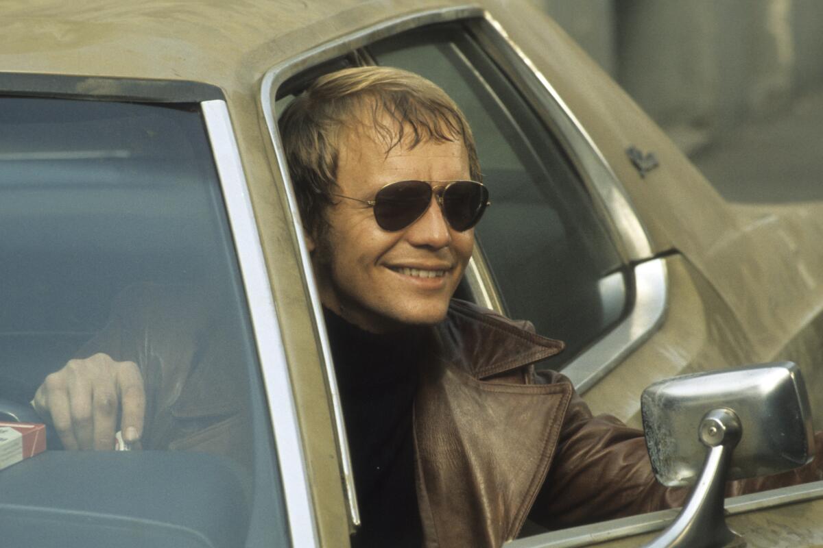 "Starsky & Hutch" actor David Soul, wearing sunglasses and leaning out of an open car door
