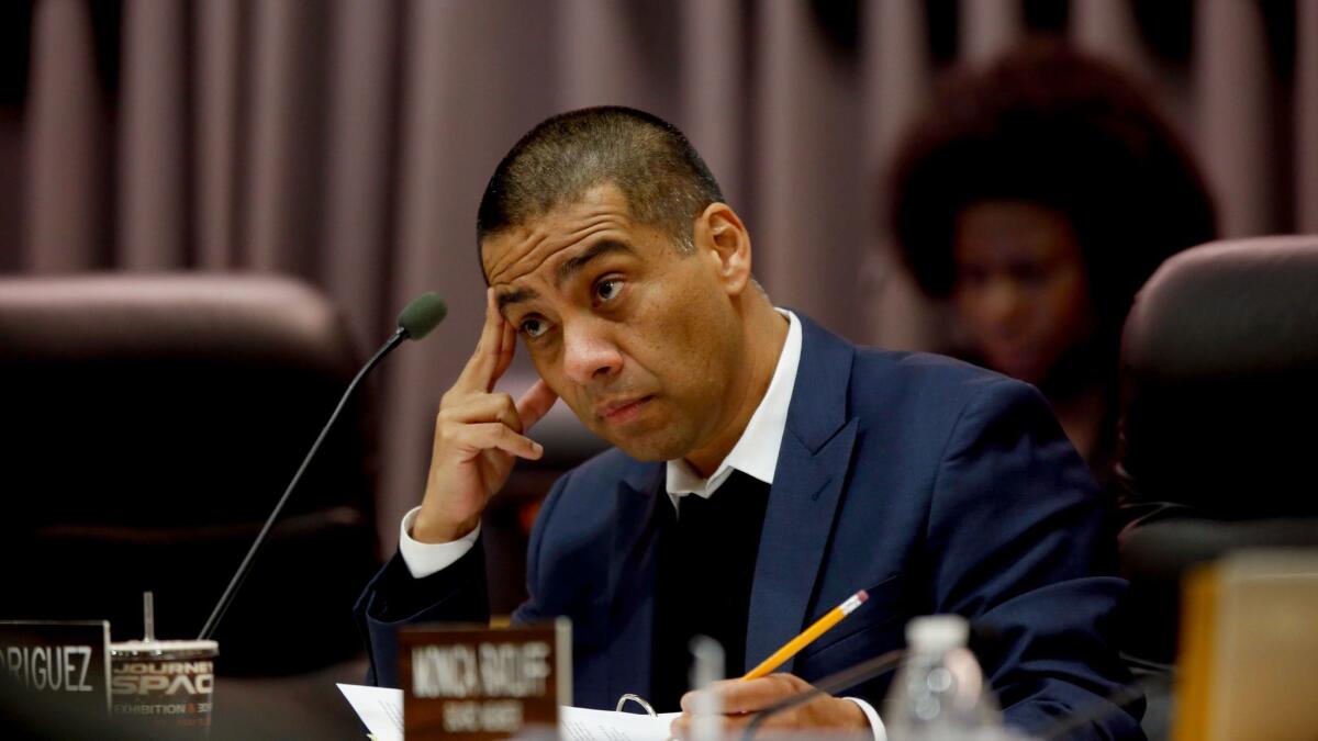 L.A. school board member Ref Rodriguez, shown here at a meeting in 2016, faces problems that include a criminal complaint and conflict-of-interest allegations.