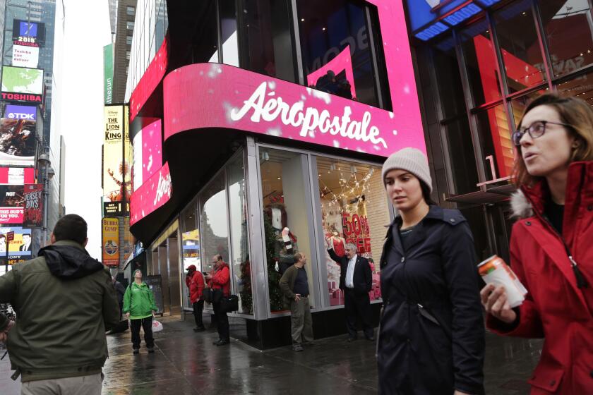Women pass an Aeropostale store in New York's Times Square on Dec. 2.